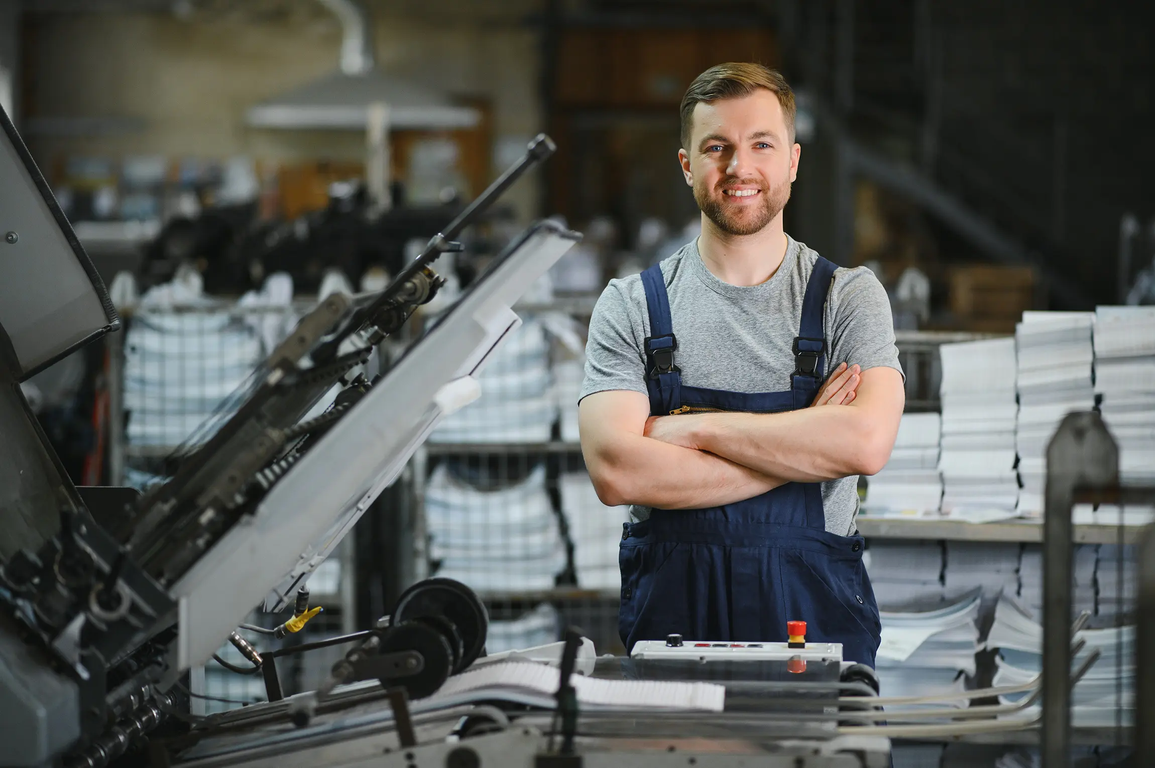 employee standing in front of a machine